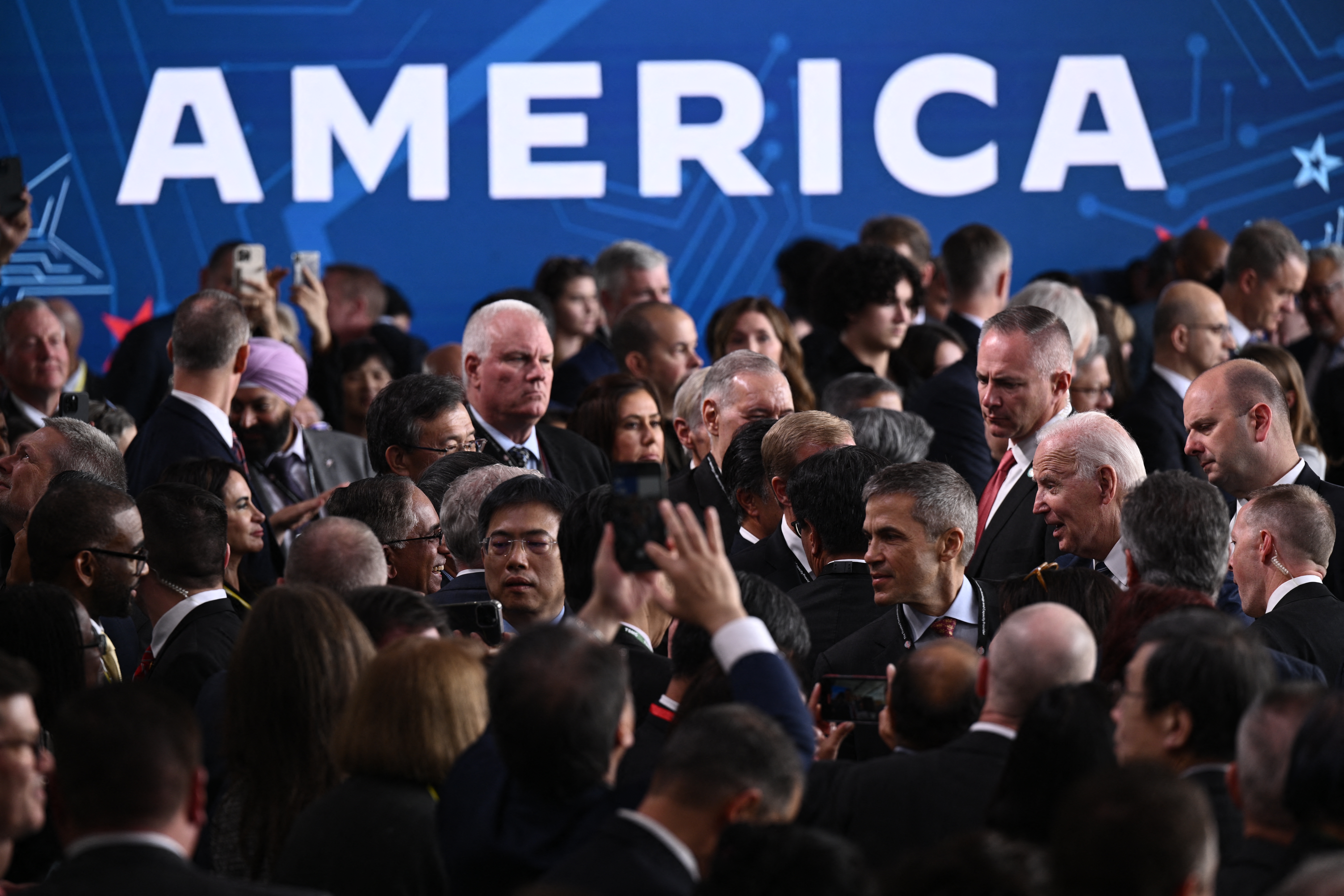 US President Joe Biden greets attendees after delivering remarks on his economic plan at TSMC chip manufacturing facility in Phoenix, Arizona, on December 6, 2022. (Photo by Brendan SMIALOWSKI/AFP).