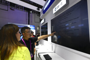 People examine an AI product of Baidu during the World Artificial Intelligence Conference (WAIC) in Shanghai on July 6, 2023. (Photo by WANG Zhao/AFP).