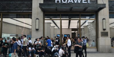 Sales of Huawei smartphones in China grew 37% YoY, commanding a 12.9% market share in the quarter while Apple declined. Photo: People queue up for hours outside Huaweis flagship store in Shanghai on September 25, 2023, hoping to be able to buy the tech giant's latest Mate 60 Pro mobile phone. (Photo by REBECCA BAILEY / AFP)