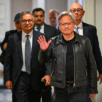 Jensen Huang, co-founder and chief executive officer (CEO) of Nvidia, waves as he arrives for a media roundtable in Kuala Lumpur on December 8, 2023. (Photo by Mohd RASFAN / AFP).