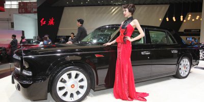 (FIle) Models pose with a Hongqi L5 car on display at the China International Exhibition Center new venue during the "Auto China 2014" Beijing International Automotive Exhibition in Beijing on April 20, 2014. Source: AFP