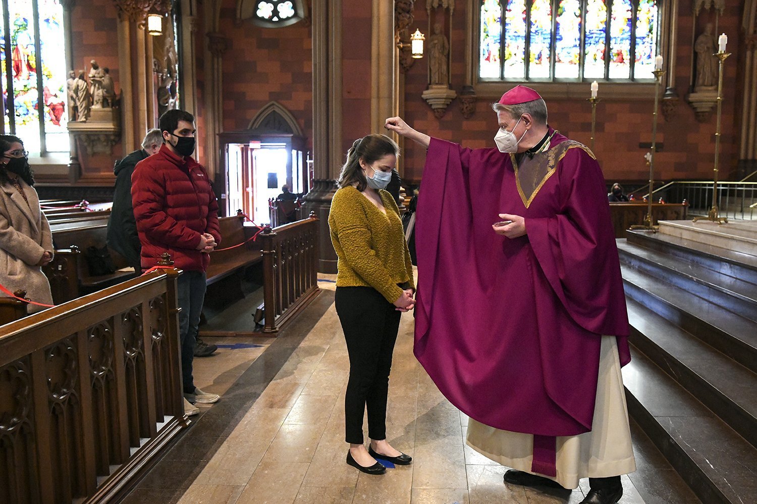 Bishop Edward B. Scharfenberger of Albany, N.Y., sprinkles ashes on parishioners. Bishop Edward B. Scharfenberger of Albany, N.Y., sprinkles ashes on parishioners.