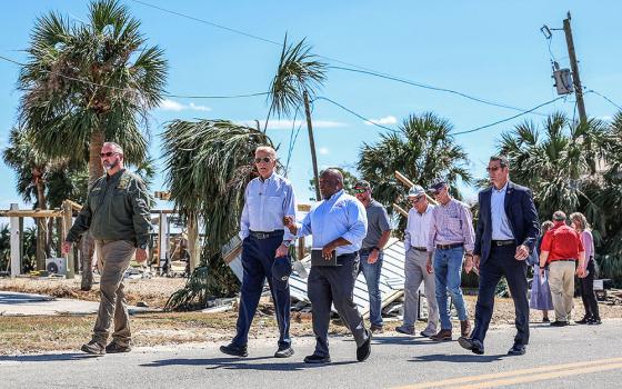 U.S. President Joe Biden speaks with a Federal Emergency Management Agency member Oct. 3, 2024, as he visits storm-damaged areas in Keaton Beach, Fla., in the wake of Hurricane Helene, which made landfall Sept. 26 in the Big Bend region of Florida, near the city of Perry. Helene was followed by Hurricane Milton, one of the strongest hurricanes ever to form in the Gulf of Mexico. Milton made landfall as a major Category 3 hurricane near Siesta Key in Sarasota Oct. 9. (OSV News/Reuters/Tom Brenner)