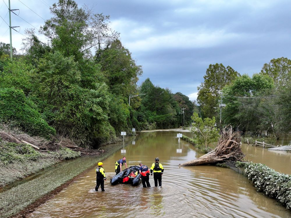 rescue personnel working in a flooded area in Asheville, N.C.,