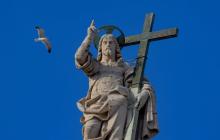 The statue of the Risen Christ on top of the facade of St. Peter's Basilica at the Vatican 
