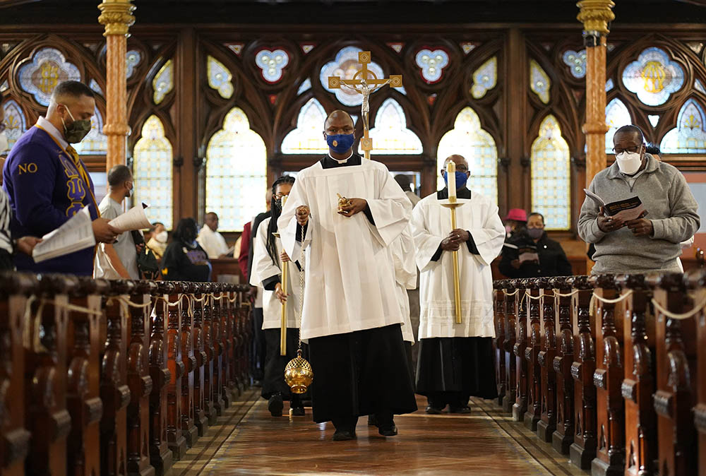 Toby Offiah, a seminarian of the Diocese of Brooklyn, leads the opening procession during a Mass marking Black Catholic History Month on Nov. 21, 2021. Toby Offiah, a seminarian of the Diocese of Brooklyn, leads the opening procession during a Mass marking Black Catholic History Month on Nov. 21, 2021.