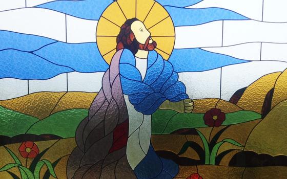 Jesus is depicted praying in a stained glass window in Bukit Doa Getsemane, Ambarita, Samosir, Indonesia (Wikimedia/Christian Advs Sltg)