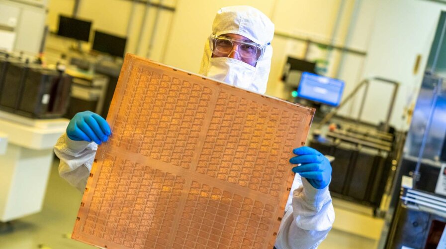 An Intel engineer holds a test glass core substrate panel at Intel's Assembly and Test Technology Development factories in Chandler, Arizona, in July 2023. Intel’s advanced packaging technologies come to life at the company's Assembly and Test Technology Development factories. (Credit: Intel Corporation)