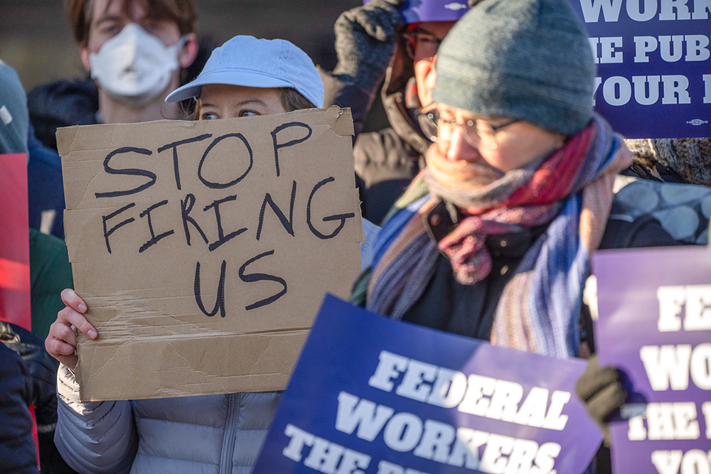 Demonstrators rally in support of federal workers outside of the Department of Health and Human Services, Feb. 14, 2025, in Washington. (AP/Mark Schiefelbein, File)